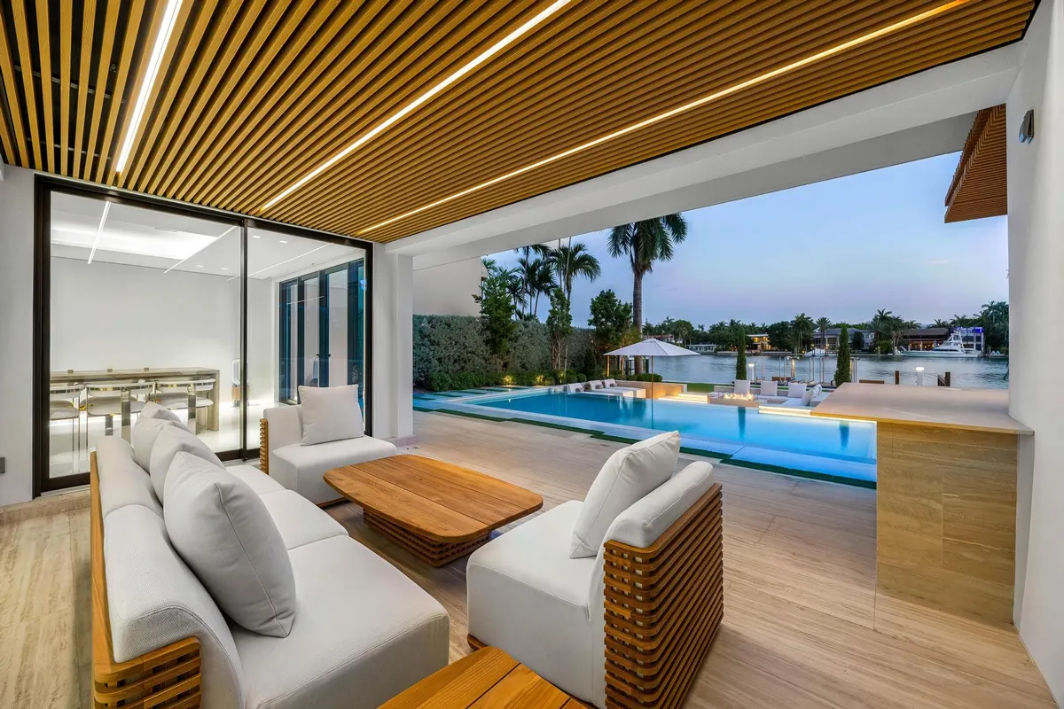 Covered outdoor seating area looking toward the pool and waterfront