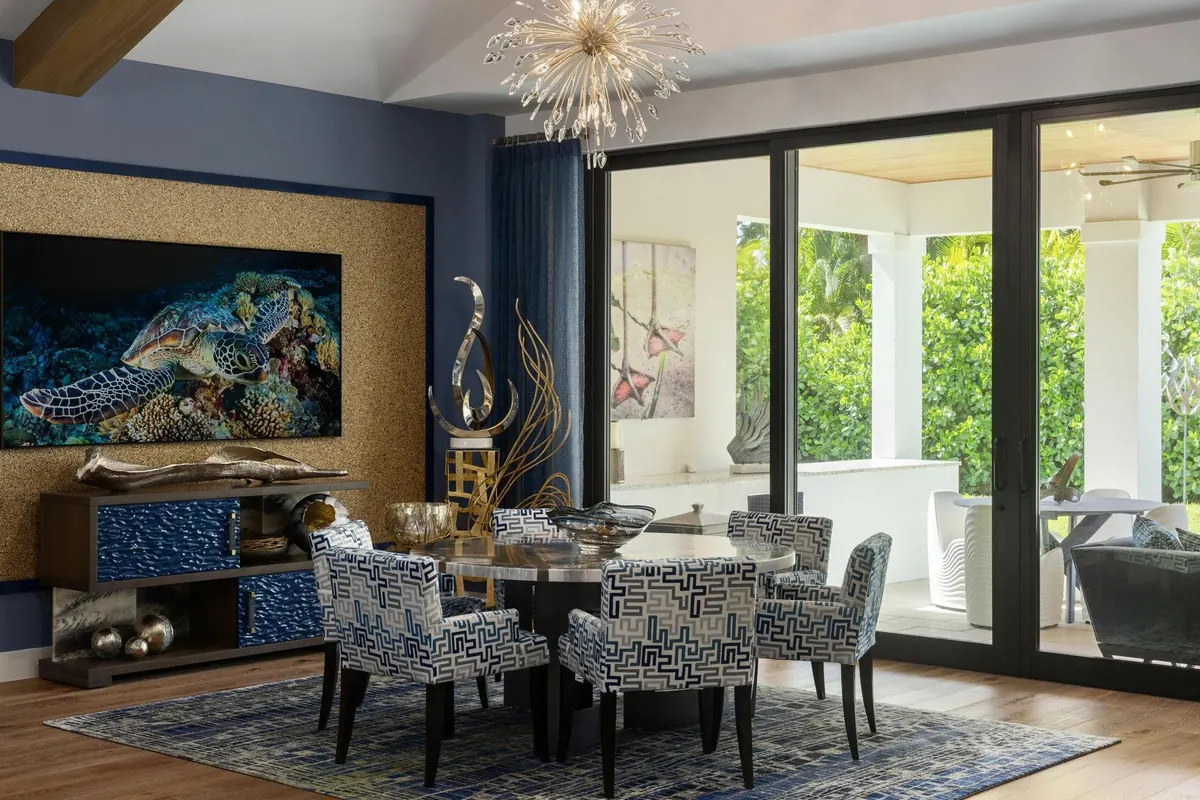 Dining room with blue walls, glass doors and a statement chandelier