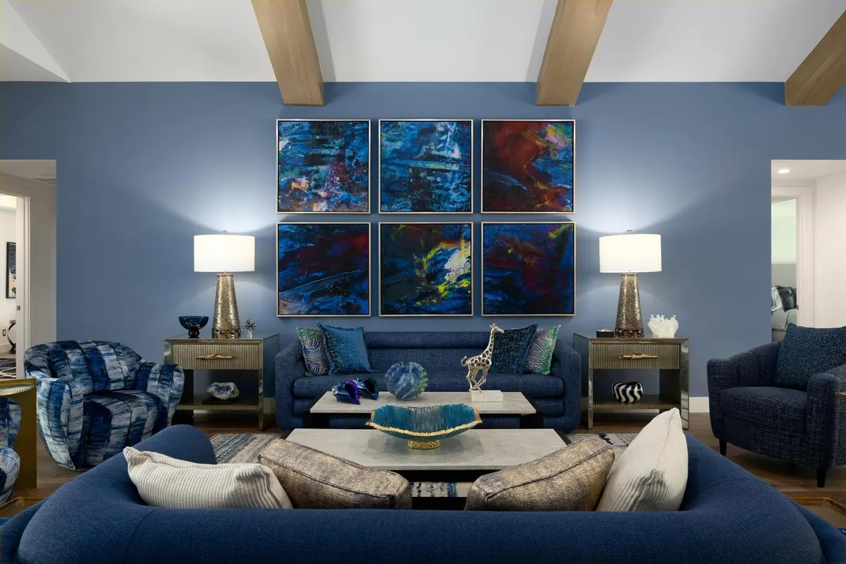 Blue living room with patterned seating and artwork