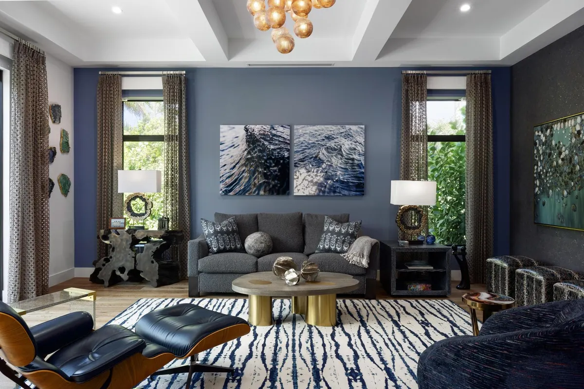 Living room with dark blue curtains, textured rug and gray seating