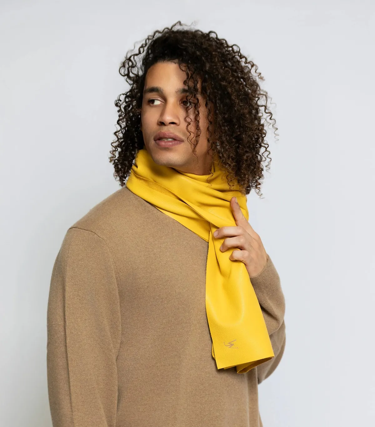 Studio portrait with a yellow scarf and camel-colored top
