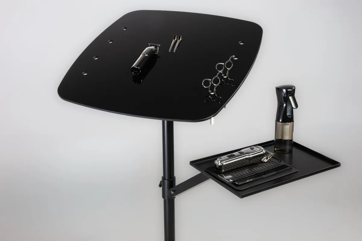 Black salon workstation and tools in a studio product photograph