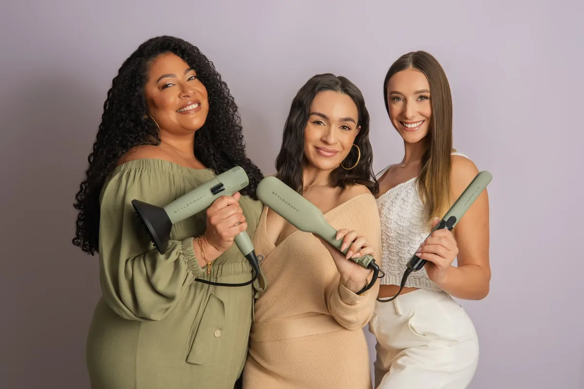 Three models with green hair styling tools in a coordinated studio photograph for Stylecraft